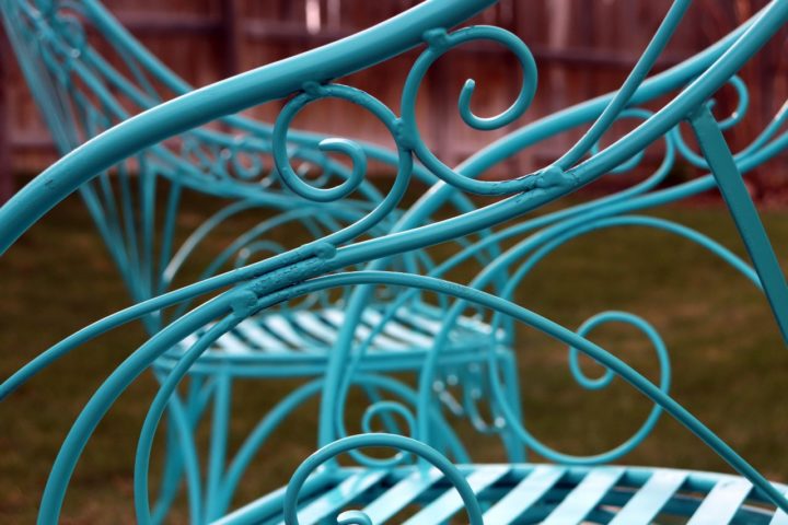 Turquoise metal patio chairs outside